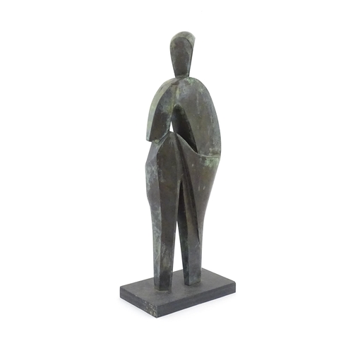 1020 - A 20thC cast bronze sculpture depicting a stylised standing figure. In the manner of JD Hansen. Appr... 