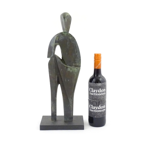 1020 - A 20thC cast bronze sculpture depicting a stylised standing figure. In the manner of JD Hansen. Appr... 