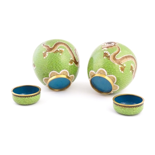 1027 - A pair of Oriental cloisonne ginger jars the green ground decorated with dragons and flaming pearl d... 