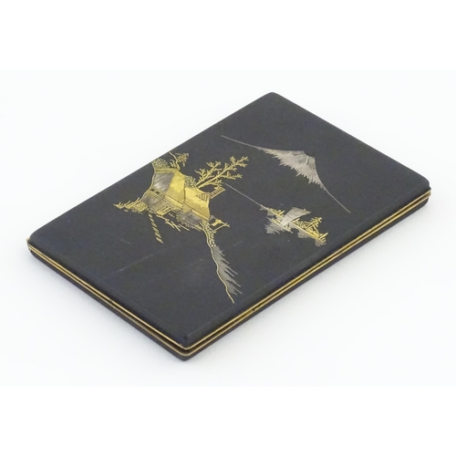 1034 - A Japanese cigarette case with Damascene decoration depicting a view of Mount Fuji. Approx. 4 3/4