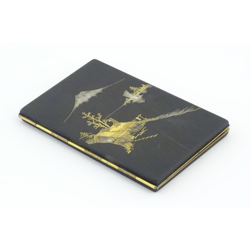 1034 - A Japanese cigarette case with Damascene decoration depicting a view of Mount Fuji. Approx. 4 3/4