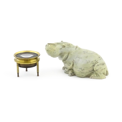 1035 - A 20thC soapstone model of a hippopotamus. Together with a thread counter / magnifier. Hippo approx.... 