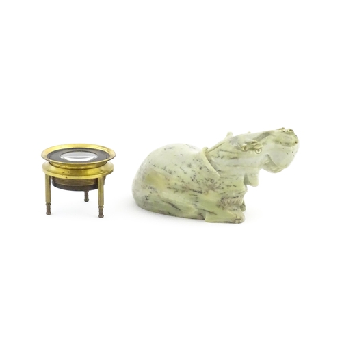 1035 - A 20thC soapstone model of a hippopotamus. Together with a thread counter / magnifier. Hippo approx.... 