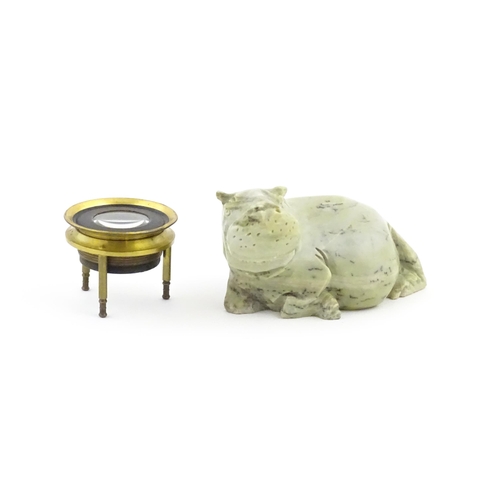 1035 - A 20thC soapstone model of a hippopotamus. Together with a thread counter / magnifier. Hippo approx.... 