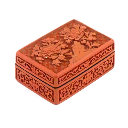 1036 - A Chinese cinnabar lacquer pot and cover of rectangular form, the lid decorated with peony flowers, ... 