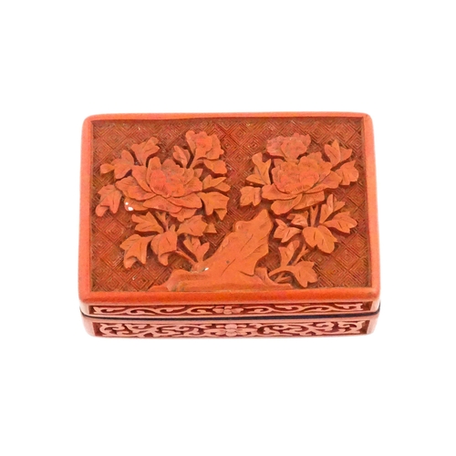 1036 - A Chinese cinnabar lacquer pot and cover of rectangular form, the lid decorated with peony flowers, ... 