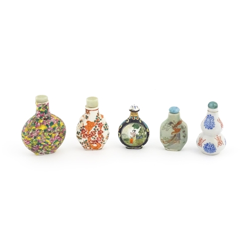 1037 - Five assorted Chinese snuff bottles to include an enamel example decorated with two scenes of figure... 