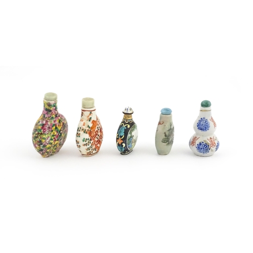 1037 - Five assorted Chinese snuff bottles to include an enamel example decorated with two scenes of figure... 