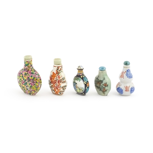 1037 - Five assorted Chinese snuff bottles to include an enamel example decorated with two scenes of figure... 