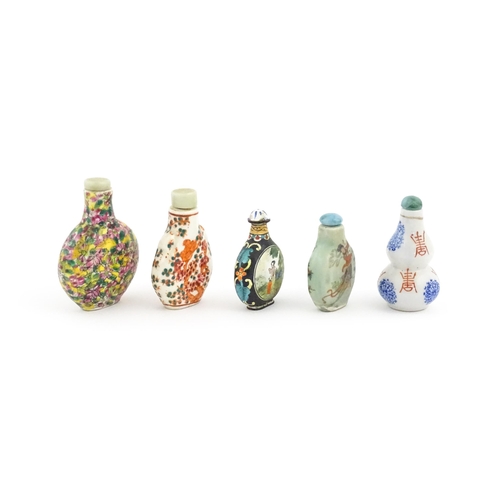 1037 - Five assorted Chinese snuff bottles to include an enamel example decorated with two scenes of figure... 