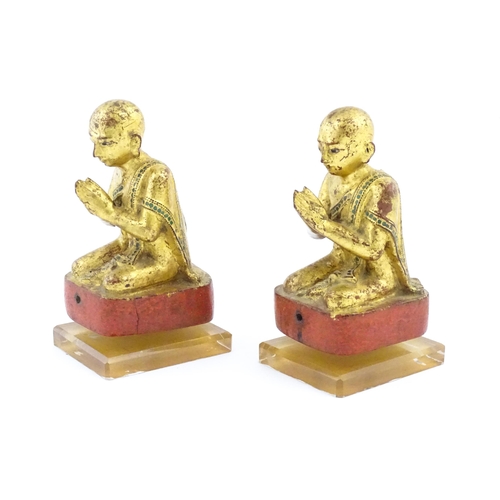 1041 - A pair of Asian carved wooden models of Buddhist monks in prayer with gilt detail. Approx. 8 1/4