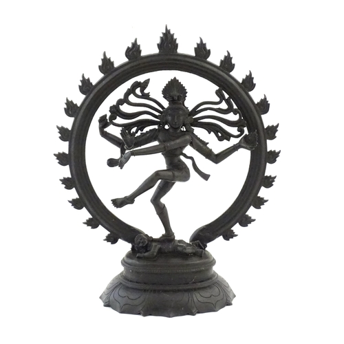 1045 - An Indian cast sculpture depicting the Hindu deity Shiva as Nataraja dancing in a stylised circle of... 