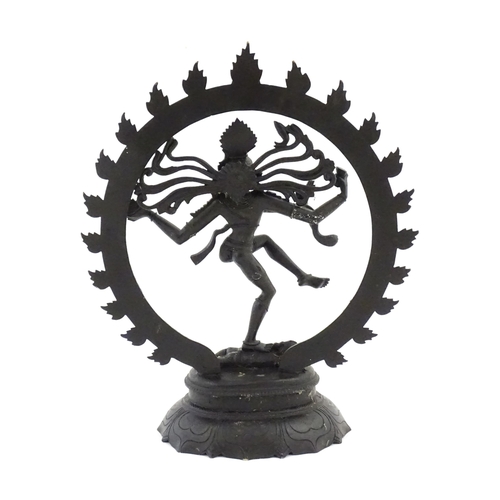 1045 - An Indian cast sculpture depicting the Hindu deity Shiva as Nataraja dancing in a stylised circle of... 