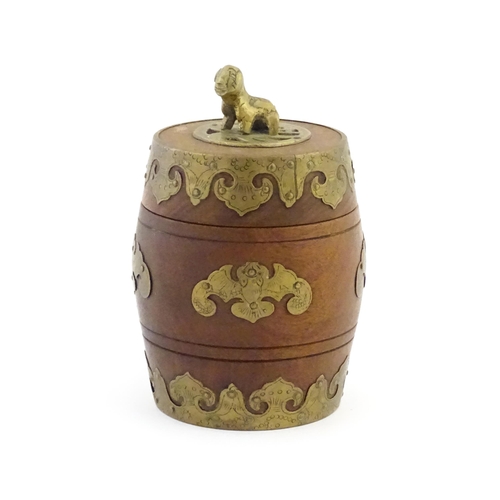 1047 - A Chinese tobacco jar of barrel form with stylised bat brass mounts and foo dog finial. Approx. 6 3/... 