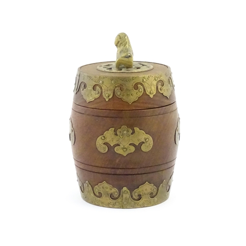 1047 - A Chinese tobacco jar of barrel form with stylised bat brass mounts and foo dog finial. Approx. 6 3/... 