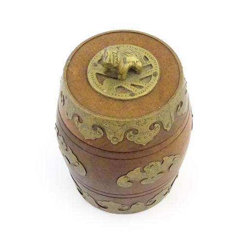 1047 - A Chinese tobacco jar of barrel form with stylised bat brass mounts and foo dog finial. Approx. 6 3/... 