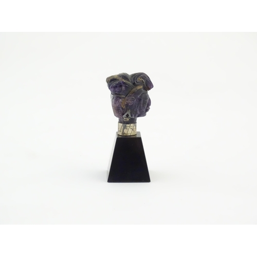 1048 - A 20thC amethyst carving modelled as a male head with headdress, mounted on a tapering plinth. Appro... 