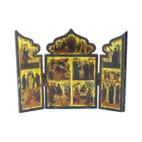 1050 - A 19thC Russian Orthodox carved wooden triptych icon with eight tempera depictions of events in the ... 