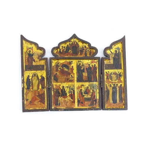 1050 - A 19thC Russian Orthodox carved wooden triptych icon with eight tempera depictions of events in the ... 