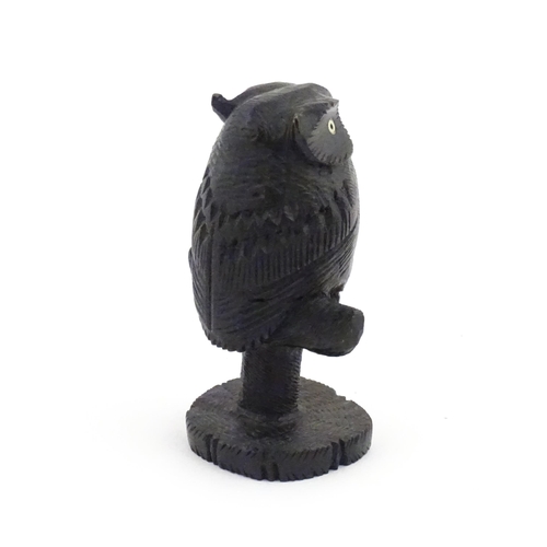 1057 - An early 20thC carved wooden model of an owl on a perch. Approx. 4 1/4