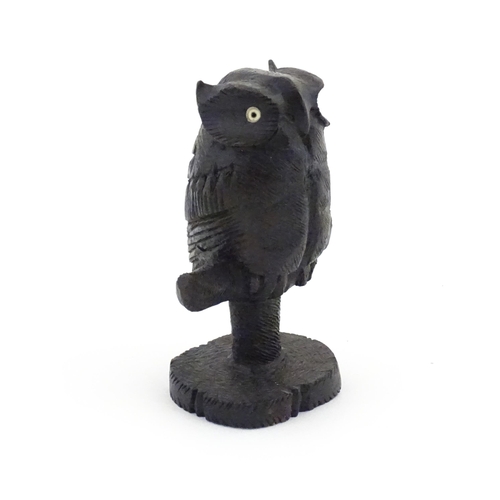 1057 - An early 20thC carved wooden model of an owl on a perch. Approx. 4 1/4