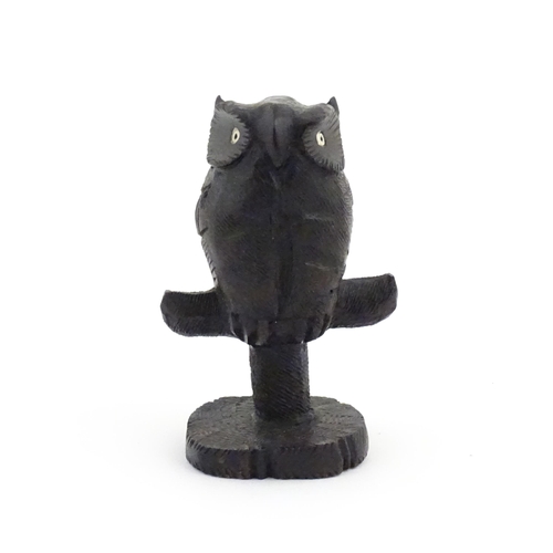 1057 - An early 20thC carved wooden model of an owl on a perch. Approx. 4 1/4