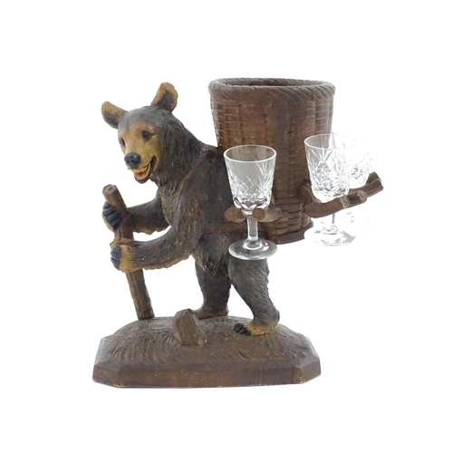 1058 - A 20thC Black Forest stand / holder, modelled as a carved hiking bear with a large basket on its bac... 