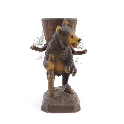 1058 - A 20thC Black Forest stand / holder, modelled as a carved hiking bear with a large basket on its bac... 