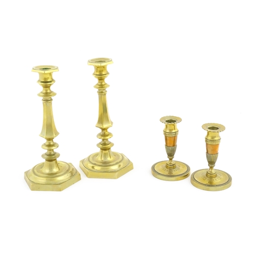 1064 - A pair of 20thC brass candlesticks. Together with a smaller pair with banded foliate detail. Largest... 