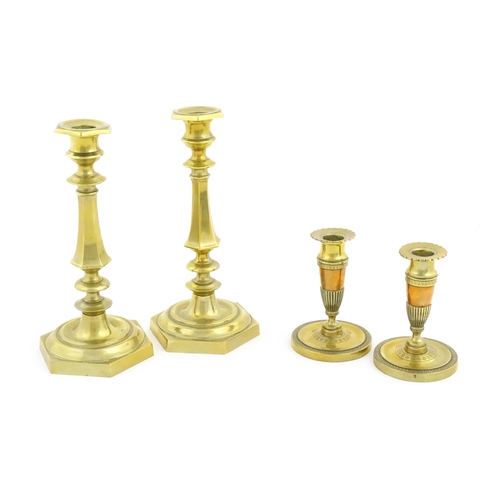 1064 - A pair of 20thC brass candlesticks. Together with a smaller pair with banded foliate detail. Largest... 