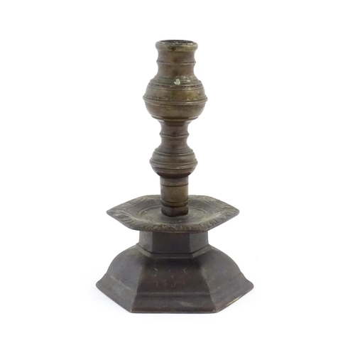 1069 - A cast candlestick, the hexagonal base marked 'OGS 1650'. Approx. 9