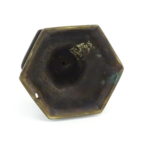 1069 - A cast candlestick, the hexagonal base marked 'OGS 1650'. Approx. 9