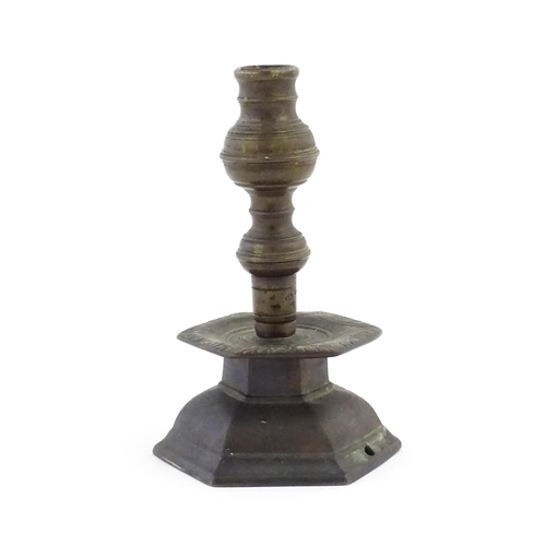 1069 - A cast candlestick, the hexagonal base marked 'OGS 1650'. Approx. 9