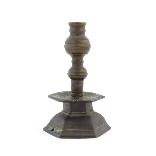 1069 - A cast candlestick, the hexagonal base marked 'OGS 1650'. Approx. 9