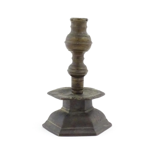 1069 - A cast candlestick, the hexagonal base marked 'OGS 1650'. Approx. 9