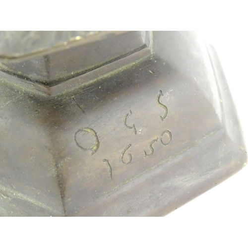 1069 - A cast candlestick, the hexagonal base marked 'OGS 1650'. Approx. 9