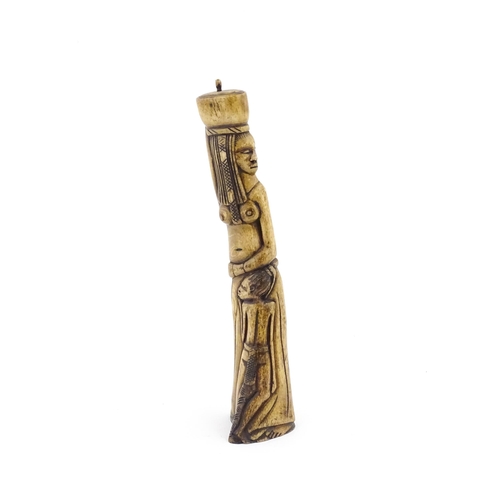 1075 - Ethnographic / Native / Tribal : An African carved bone with figural detail. Approx. 9 3/4