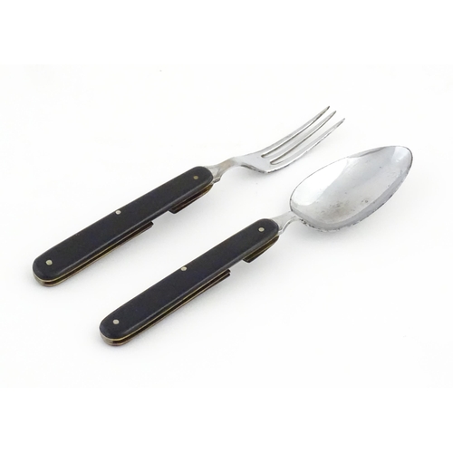 1085 - A 20thC campaign style folding spoon and fork. (2)