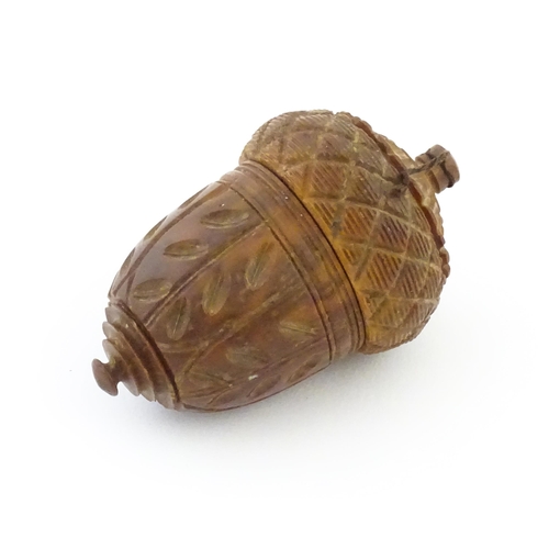 1093 - A late 19th / early 20thC carved coquilla nut nutmeg grater of acorn form. Approx. 2 3/4