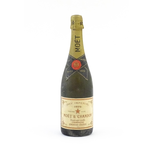 1102 - A 1975 75cl bottle of Moet & Chandon dry imperial champagne.