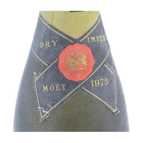 1102 - A 1975 75cl bottle of Moet & Chandon dry imperial champagne.