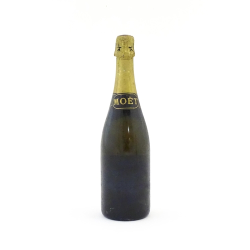 1102 - A 1975 75cl bottle of Moet & Chandon dry imperial champagne.