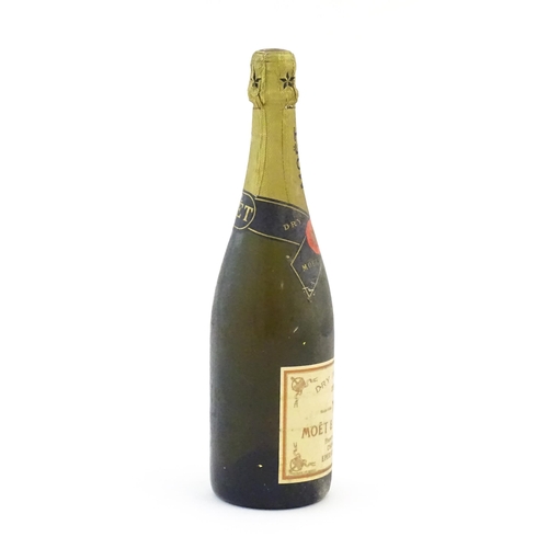 1102 - A 1975 75cl bottle of Moet & Chandon dry imperial champagne.