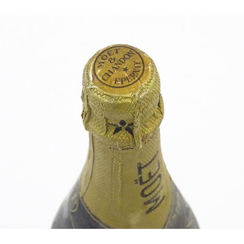 1102 - A 1975 75cl bottle of Moet & Chandon dry imperial champagne.