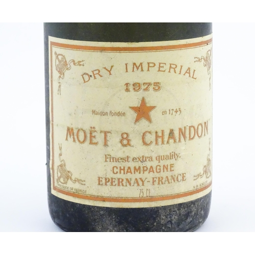 1102 - A 1975 75cl bottle of Moet & Chandon dry imperial champagne.