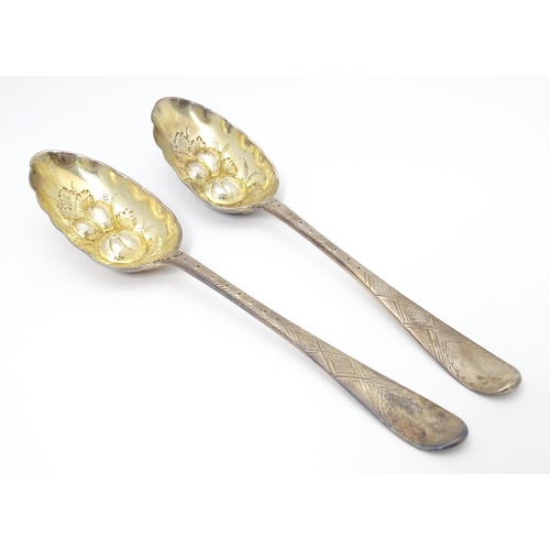 545 - A pair of Geo III Scottish silver berry spoons with engraved armorial to handle, hallmarked Edinburg... 