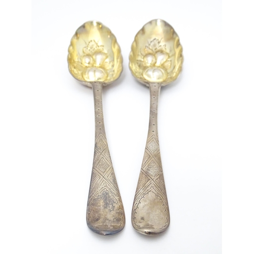 545 - A pair of Geo III Scottish silver berry spoons with engraved armorial to handle, hallmarked Edinburg... 