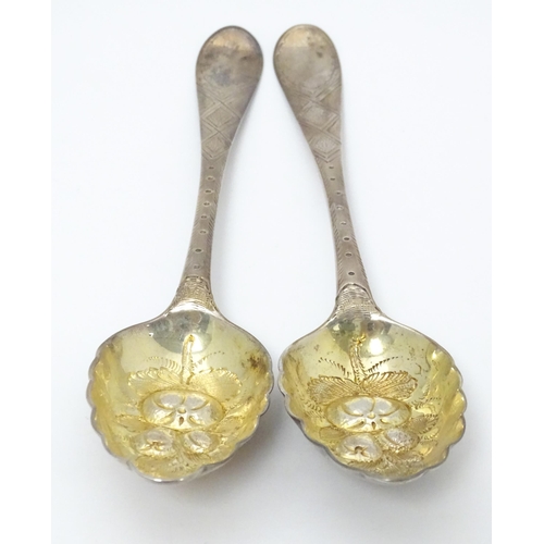 545 - A pair of Geo III Scottish silver berry spoons with engraved armorial to handle, hallmarked Edinburg... 