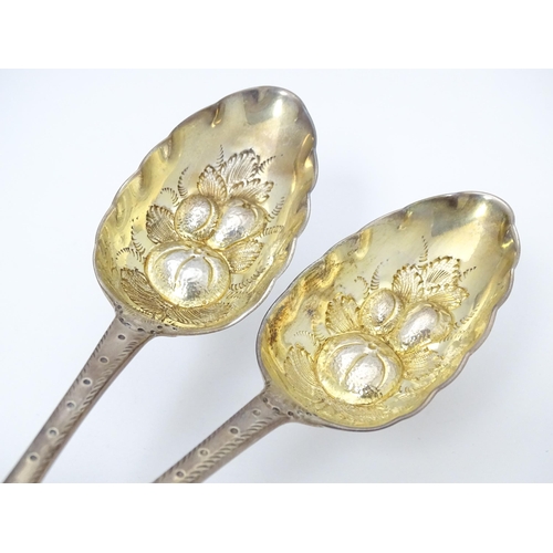 545 - A pair of Geo III Scottish silver berry spoons with engraved armorial to handle, hallmarked Edinburg... 