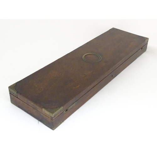 1216 - A 19thC mahogany gun motor case brass mounts, the green baize-lined interior fitted for a side by si... 